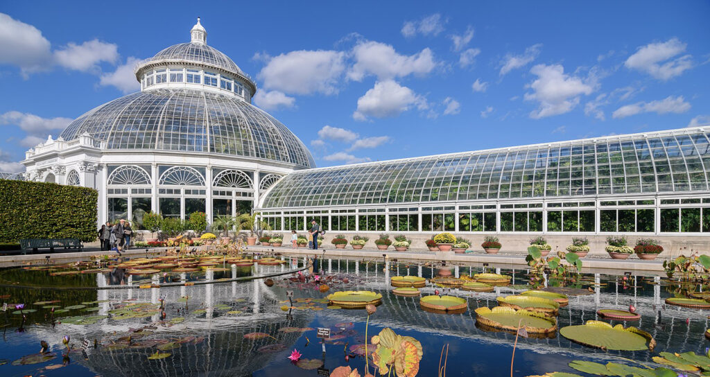 Luxury black car or limo parked outside the New York Botanical Garden entrance, ready for pickup or drop-off.