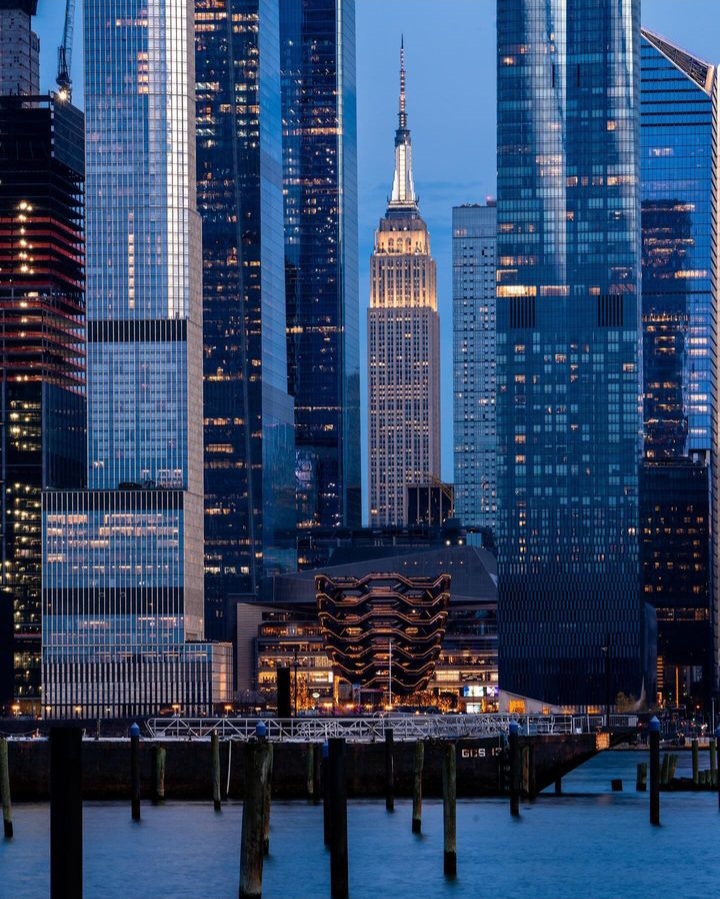 View of Hudson Yards with The Empire State Building overlooking the Vessel.